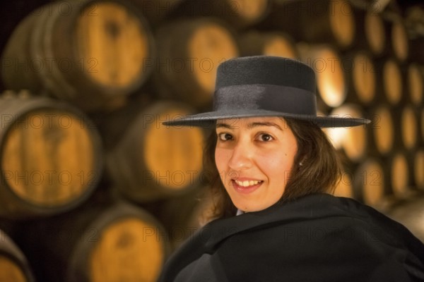 Classic travel guide with student robe, zorro hat and cape, port wine barrels, wine cellar of the Sandemann winery in Gaia, Porto, Vila Nova de Gaia, Porto district, Portugal, Europe, aerial view, birds-eyes view, Travel, travel photography