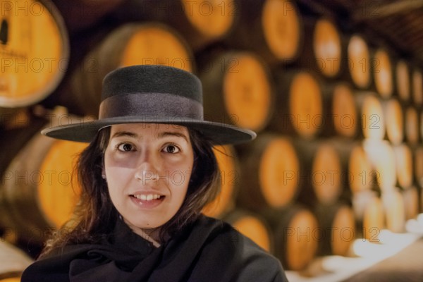 Classic travel guide with student robe, zorro hat and cape, port wine barrels, wine cellar of the Sandemann winery in Gaia, Porto, Vila Nova de Gaia, Porto district, Portugal, Europe, aerial view, birds-eyes view, Travel, travel photography