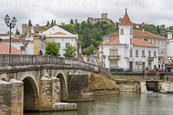 Renaissance bridge Ponte Velha over the Nabao near the historic centre of Tomar with the Convento de Cristo in the background, Tomar, Santarém district, Portugal