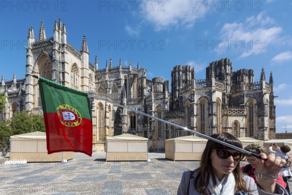 Travel guide in front of the monastery, Monastery of Santa Maria da VitÃüria, UNESCO World Heritage Site, Monastery Church of Batalha, Mosteiro da Batalha, Batalha, Leiria District, Portugal, Europe, aerial view, birds-eyes view, Travel, travel photography