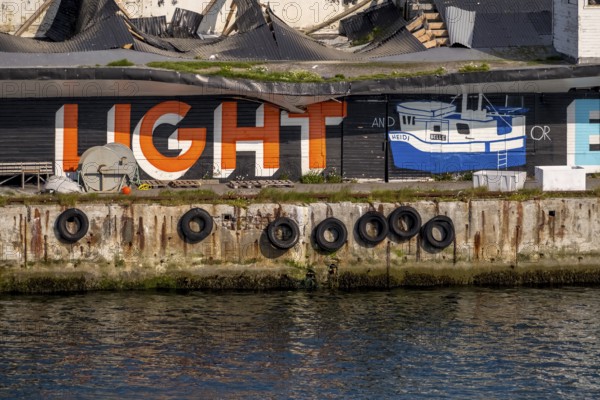 Street Art Eternal Light Eternal Night, in the harbour, Vardø, Finnmark, Norway, Scandinavia, Europe, adventure travel, tourism, graffiti eternal light eternal night, graphic Heidi Schiff, Hurtigruten, Hurtigrutenreise, cruise, NOR, travel, destination, sea voyage, sightseeing, tourism, Norwegian, Scandinavian, touristic