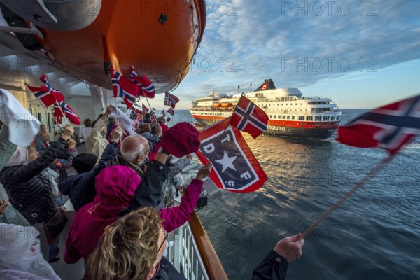 Tourists at the ship's railing, ship MS Finnmarken, Norwegian flags, Mehamn, Finnmark, Norway, Scandinavia, Europe, adventure trip, welcoming the passengers, Berlevåg, tourism, Hurtigruten, Hurtigruten voyage, cruise, cruise ship, liner service, NOR, passenger ship, shipping company Hurtigruten AS, travel, destination, shipping, sea voyage, sightseeing, tourism, Norwegian, Norwegian flag, Scandinavian, touristic