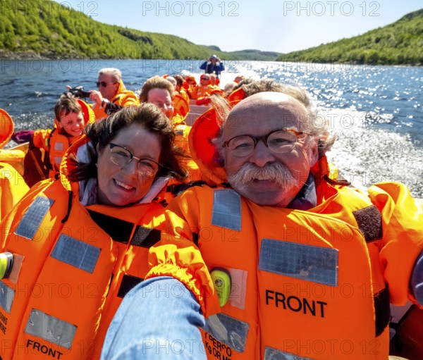 Selfie, tourists with life jackets, river trip with tourists on an excursion boat in a headwind, Kirkenes, Finnmark, Norway, Scandinavia, Europe, adventure trip, boat trips, rigid-hull inflatable boat, river trip, tourism, Hurtigruten, Hurtigruten trip, cruise, NOR, RIB boat, travel, destination, life jackets, sea trip, sightseeing, speedboat, tourism, Norwegian, Scandinavian, touristic