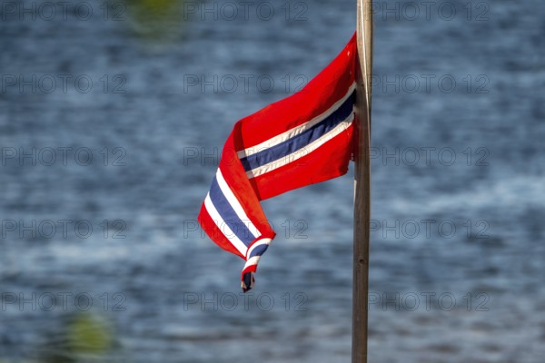 Norwegian flag on the river, Kirkenes, Finnmark, Norway, Scandinavia, Europe, adventure travel, tourism, Hurtigruten, Hurtigruten voyage, cruise, NOR, travel, destination, sea voyage, sightseeing, tourism, Norwegian, Scandinavian, touristic
