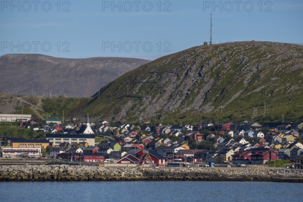 View of village with church in front of mountain range, Kjøllefjord, Finnmark, Norway, Scandinavia, Europe, adventure travel, fjord, tourism, Hurtigruten, Hurtigruten voyage, Kjøllefjord, cruise, NOR, travel, destination, sea voyage, sightseeing, tourism, Norwegian, Scandinavian, touristic