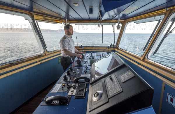 MS Polarlys, command bridge, officer on bridge, Honningsvåg, Finnmark, Norway, Scandinavia, Europe, adventure travel, tourism, Honningsvåg, Hurtigruten, Hurtigruten voyage, command post, cruise, cruise ship, NOR, navigation technology, travel, destination, ship, shipping, ship bridge, ship officer, sea voyage, sightseeing, controls, tourism, Norwegian, Scandinavian, touristic