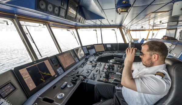 MS Polarlys, command bridge, officer on bridge, Honningsvåg, Finnmark, Norway, Scandinavia, Europe, adventure travel, binoculars, tourism, Honningsvåg, Hurtigruten, Hurtigruten voyage, command post, cruise, cruise ship, NOR, navigation technology, travel, destination, ship, shipping, ship's bridge, ship's officer, sea voyage, sighting, sightseeing, controls, tourism, Norwegian, Scandinavian, touristic