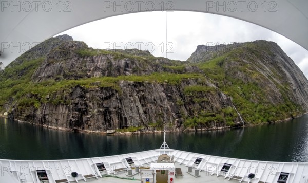 Cruise in a fjord, ship bow, Digermulen, Nordland, Norway, Scandinavia, Europe, adventure trip, mountains, mountainside, ridge, cliff, fjord, tourism, mountain, mountain range, mountain landscape, mountain range, Hurtigruten, Hurtigruten voyage, cruise, cruise ship, liner, NOR, passenger ship, travel, destination, shipping, sea voyage, sightseeing, escarpment, tourism, tourist, Norwegian, Scandinavian, touristic