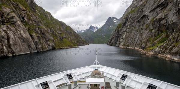 Cruise in a fjord, ship bow, Digermulen, Nordland, Norway, Scandinavia, Europe, adventure trip, mountains, mountainside, ridge, cliff, fjord, tourism, mountain, mountain range, mountain landscape, mountain range, Hurtigruten, Hurtigruten voyage, cruise, cruise ship, liner, NOR, passenger ship, travel, destination, shipping, sea voyage, sightseeing, escarpment, tourism, tourist, Norwegian, Scandinavian, touristic