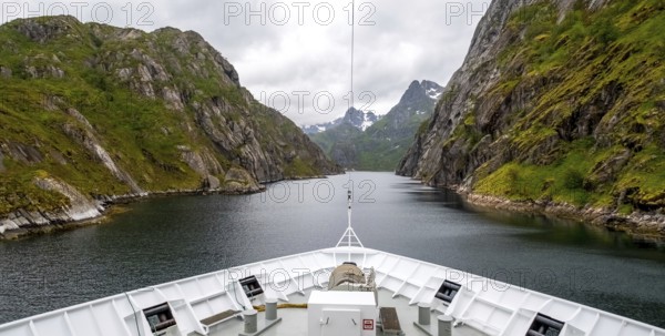 Cruise in a fjord, ship bow, Digermulen, Nordland, Norway, Scandinavia, Europe, adventure trip, mountains, mountainside, ridge, cliff, fjord, tourism, mountain, mountain range, mountain landscape, mountain range, Hurtigruten, Hurtigruten voyage, cruise, cruise ship, liner, NOR, passenger ship, travel, destination, shipping, sea voyage, sightseeing, escarpment, tourism, tourist, Norwegian, Scandinavian, touristic