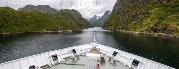Cruise in a fjord, ship bow, Digermulen, Nordland, Norway, Scandinavia, Europe, adventure trip, mountains, mountainside, ridge, cliff, fjord, tourism, mountain, mountain range, mountain landscape, mountain range, Hurtigruten, Hurtigruten voyage, cruise, cruise ship, liner, NOR, passenger ship, travel, destination, shipping, sea voyage, sightseeing, escarpment, tourism, tourist, Norwegian, Scandinavian, touristic
