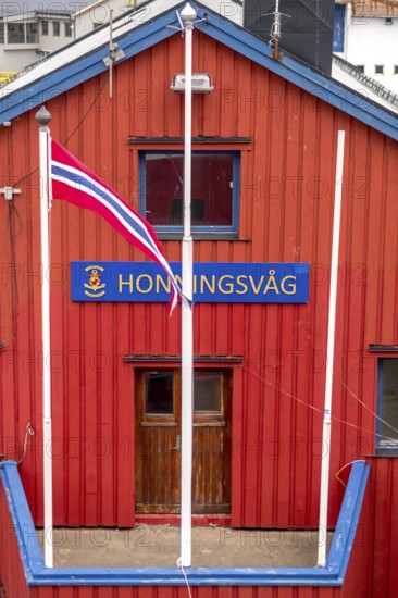 Red Norwegian house with town sign, Måsøy, Finnmark, Norway, Scandinavia, Europe, adventure trip, shapes and colours, tourism, Hurtigruten, Hurtigruten trip, cruise, Måsøy, NOR, travel, destination, sea trip, sightseeing, tourism, Norwegian, Norwegian flag, Scandinavian, touristic
