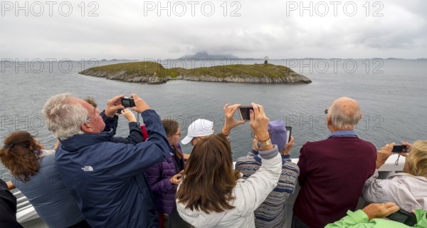 Arctic Circle Globe, Polar Circle Globe, Vikingen Island, photographing tourists, Tonnes, Nordland, Norway, Scandinavia, Europe, adventure travel, tourism, globe, Hurtigruten, Hurtigruten voyage, cruise, lighthouse tip, NOR, Arctic Circle 66° 33', Arctic Circle Monument, travel, destination, sea voyage, sightseeing, sculpture, statue, tourism, tourists, Norwegian, Scandinavian, tourist, mobile phone photography, mobile phone pictures, landmark