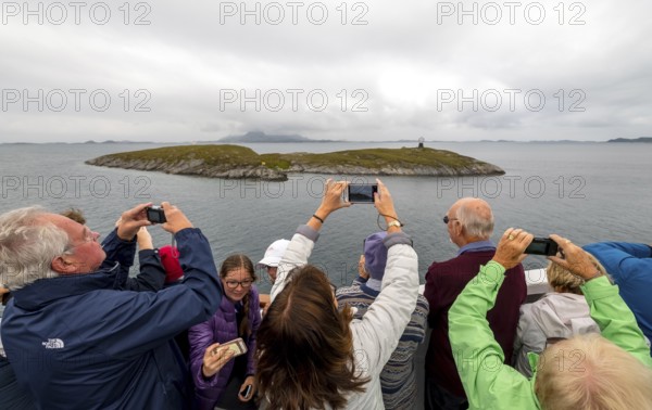 Arctic Circle Globe, Polar Circle Globe, Vikingen Island, photographing tourists, Tonnes, Nordland, Norway, Scandinavia, Europe, adventure travel, tourism, globe, Hurtigruten, Hurtigruten voyage, cruise, lighthouse tip, NOR, Arctic Circle 66° 33', Arctic Circle Monument, travel, destination, sea voyage, sightseeing, sculpture, statue, tourism, tourists, Norwegian, Scandinavian, tourist, mobile phone photography, mobile phone pictures, landmark
