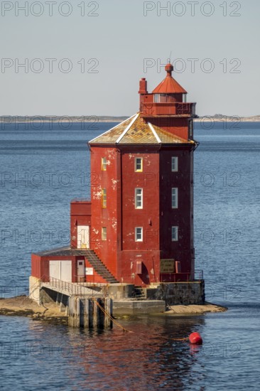 Kjeungskjær Fyr, red lighthouse, off the Norwegian coast on a small archipelago off Ã˜rland, Trø¸ndelag.Uthaug, Trø¸ndelag, Norway, Scandinavia, Europe, adventure travel, monument protection, fjord, tourism, Hurtigruten, Hurtigruten voyage, island, cruise, coast, coastal landscape, lighthouse, NOR, travel, destination, skerry, sea voyage, seabird sanctuary, sightseeing, tourism, Trøndelag, tower, Uthaug, octagonal, Norwegian, red colour, red facade, Scandinavian, touristy, Red Lighthouse, wooden lighthouse, historic lighthouse, landmark, landmarking