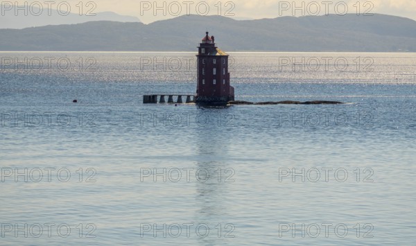 Kjeungskjær Fyr, red lighthouse, off the Norwegian coast on a small archipelago off Ã˜rland, Trø¸ndelag.Uthaug, Trø¸ndelag, Norway, Scandinavia, Europe, adventure travel, monument protection, fjord, tourism, Hurtigruten, Hurtigruten voyage, island, cruise, coast, coastal landscape, lighthouse, NOR, travel, destination, skerry, sea voyage, seabird sanctuary, sightseeing, tourism, Trøndelag, tower, Uthaug, octagonal, Norwegian, red colour, red facade, Scandinavian, touristy, Red Lighthouse, wooden lighthouse, historic lighthouse, landmark, landmarking