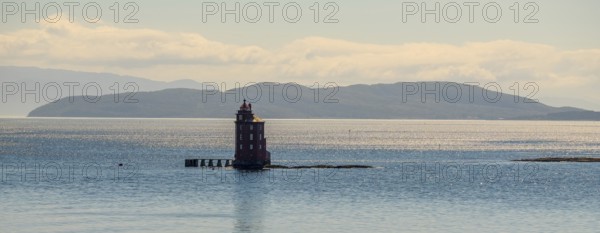 Kjeungskjær Fyr, red lighthouse, off the Norwegian coast on a small archipelago off Ã˜rland, Trø¸ndelag.Uthaug, Trø¸ndelag, Norway, Scandinavia, Europe, adventure travel, monument protection, fjord, tourism, Hurtigruten, Hurtigruten voyage, island, cruise, coast, coastal landscape, lighthouse, NOR, travel, destination, skerry, sea voyage, seabird sanctuary, sightseeing, tourism, Trøndelag, tower, Uthaug, octagonal, Norwegian, red colour, red facade, Scandinavian, touristy, Red Lighthouse, wooden lighthouse, historic lighthouse, landmark, landmarking
