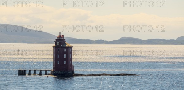 Kjeungskjær Fyr, red lighthouse, off the Norwegian coast on a small archipelago off Ã˜rland, Trø¸ndelag.Uthaug, Trø¸ndelag, Norway, Scandinavia, Europe, adventure travel, monument protection, fjord, tourism, Hurtigruten, Hurtigruten voyage, island, cruise, coast, coastal landscape, lighthouse, NOR, travel, destination, skerry, sea voyage, seabird sanctuary, sightseeing, tourism, Trøndelag, tower, Uthaug, octagonal, Norwegian, red colour, red facade, Scandinavian, touristy, Red Lighthouse, wooden lighthouse, historic lighthouse, landmark, landmarking