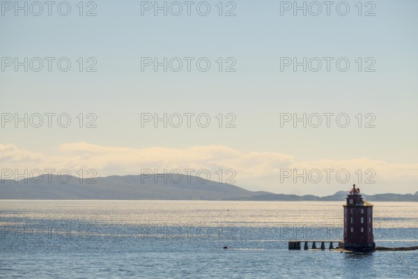 Kjeungskjær Fyr, red lighthouse, off the Norwegian coast on a small archipelago off Ã˜rland, Trø¸ndelag.Uthaug, Trø¸ndelag, Norway, Scandinavia, Europe, adventure travel, monument protection, fjord, tourism, Hurtigruten, Hurtigruten voyage, island, cruise, coast, coastal landscape, lighthouse, NOR, travel, destination, skerry, sea voyage, seabird sanctuary, sightseeing, tourism, Trøndelag, tower, Uthaug, octagonal, Norwegian, red colour, red facade, Scandinavian, touristy, Red Lighthouse, wooden lighthouse, historic lighthouse, landmark, landmarking