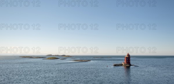 Kjeungskjær Fyr, red lighthouse, off the Norwegian coast on a small archipelago off Ørland, Trø¸ndelag.Uthaug, Trø¸ndelag, Norway, Scandinavia, Europe, adventure travel, monument protection, fjord, tourism, Hurtigruten, Hurtigruten voyage, island, cruise, coast, coastal landscape, lighthouse, NOR, travel, destination, skerry, sea voyage, seabird sanctuary, sightseeing, tourism, Trøndelag, tower, Uthaug, octagonal, Norwegian, red colour, red facade, Scandinavian, touristy, Red Lighthouse, wooden lighthouse, historic lighthouse, landmark, landmarking