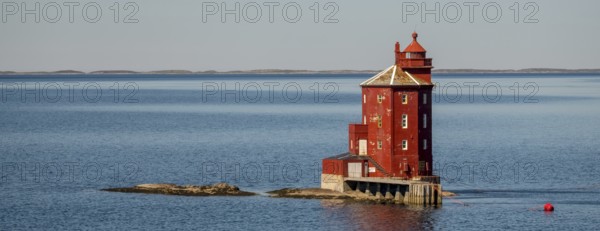 Kjeungskjær Fyr, red lighthouse, off the Norwegian coast on a small archipelago off Ã˜rland, Trø¸ndelag.Uthaug, Trø¸ndelag, Norway, Scandinavia, Europe, adventure travel, monument protection, fjord, tourism, Hurtigruten, Hurtigruten voyage, island, cruise, coast, coastal landscape, lighthouse, NOR, travel, destination, skerry, sea voyage, seabird sanctuary, sightseeing, tourism, Trøndelag, tower, Uthaug, octagonal, Norwegian, red colour, red facade, Scandinavian, touristy, Red Lighthouse, wooden lighthouse, historic lighthouse, landmark, landmarking