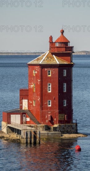 Kjeungskjær Fyr, red lighthouse, off the Norwegian coast on a small skerry off Ørland, Trøndelag.Uthaug, Trøndelag, Norway, Scandinavia