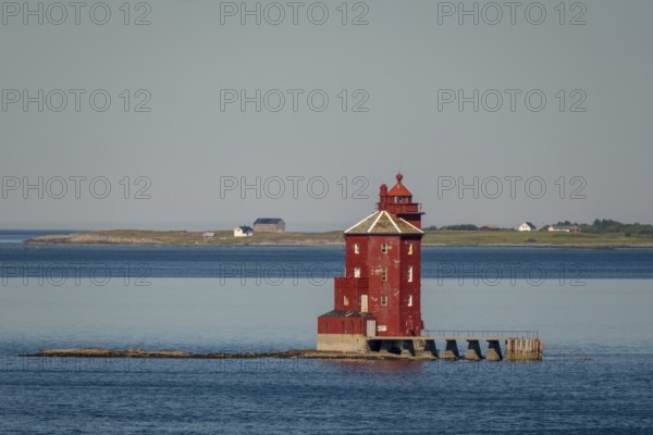 Kjeungskjær Fyr, red lighthouse, off the Norwegian coast on a small archipelago off Ã˜rland, Trø¸ndelag.Uthaug, Trø¸ndelag, Norway, Scandinavia, Europe, adventure travel, monument protection, fjord, tourism, Hurtigruten, Hurtigruten voyage, island, cruise, coast, coastal landscape, lighthouse, NOR, travel, destination, skerry, sea voyage, seabird sanctuary, sightseeing, tourism, Trøndelag, tower, Uthaug, octagonal, Norwegian, red colour, red facade, Scandinavian, touristy, Red Lighthouse, wooden lighthouse, historic lighthouse, landmark, landmarking