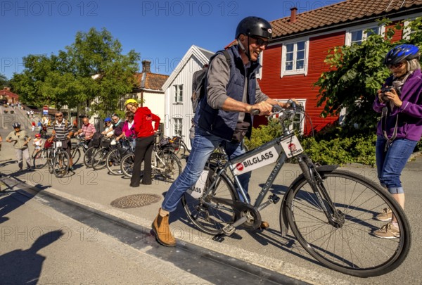Tourist at bike rental, Trondheim, bike lift, Trøndelag, Norway, Scandinavia, Europe, adventure travel, bicycle, tourism, Hurtigruten, Hurtigruten trip, cruise, NOR, travel, destination, sea trip, sightseeing, Sykkelservice, tourism, Trøndelag, Norwegian, Scandinavian, touristic