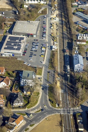 Aerial view, construction site construction work at Werl station, shopping centre with Aldi and Rewe supermarket, Werl, Soester Börde, North Rhine-Westphalia, Germany, railway area, station, station forecourt, platform, construction work, construction area, building site, building plots, construction project, construction project, construction site, DE, Deutsche Bahn AG, shopping centre, shopping markets, shopping square, shopping centre, Europe, tracks, main station, aerial view, aerial photography, aerial photography, local supply centre, new building, supermarket, overview, bird's-eye view, overview