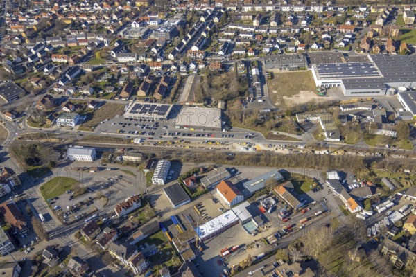 Aerial view, construction site construction work at Werl station and station forecourt, shopping centre with Aldi and Rewe supermarket, Werl, Soester Börde, North Rhine-Westphalia, Germany, railway area, station, station forecourt, platform, construction work, construction area, building site, building plots, construction project, construction project, construction site, DE, Deutsche Bahn AG, shopping centre, shopping markets, shopping square, shopping centre, Europe, tracks, main station, aerial view, aerial photography, aerial photography, local supply centre, new construction, supermarket, overview, bird's-eye view, overview