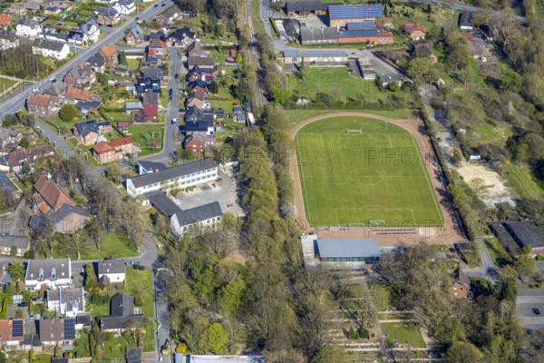 Aerial view, primary school Kardinal-von-Galen-Schule and sports centre SV 47/63 Stockum e. V. football stadium, left catholic church St. Sophia, Stockum, Werne, Ruhr area, North Rhine-Westphalia, Germany, education, educational institution, DE, Europe, football pitch, football stadium, educational institute, aerial view, aerial photography, aerial photography, Münsterland, school, sports, sports facilities, sports field, sports facility, stadium, overview, bird's eye view, bird's eye view, overview