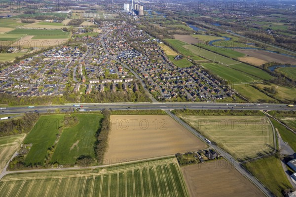 Aerial view, residential area, Stockum district with view to the WE Generation SE power plant Gersteinwerk, Stockum, motorway A1 and on the right the nature reserve Lippeaue from Stockum to Werne, Werne, Ruhr area, North Rhine-Westphalia, Germany, DE, Europe, property tax, real estate, aerial view, aerial photography, aerial photography, Münsterland, overview, bird's eye view, residential area, living and life, residential area, residential quality, residential quarter, housing estate, residential area, birds-eyes view, overview