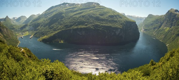 GeirangerFjord Loop, Geiranger town view, Queen Elisabeth and MSC Orchestra ship at anchor, Møre og Romsdal, Norway, Scandinavia, Europe, adventure trip, mountains and valleys, mountainside, mountain ridge, tourism, mountain range, mountain landscape, Geiranger, harbour, Hurtigruten, Hurtigruten voyage, hilly landscape, cruise, cruise ship, Møre og Romsdal, NOR, travel, destination, ship, sea voyage, sightseeing, tourism, UNESCO World Heritage Site, forest area, Norwegian, Scandinavian, touristic