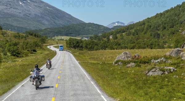 Motorcyclist and coach on the European route 63, Geiranger, Møre og Romsdal, Norway, Scandinavia, Europe, adventure trip, mountains, tourism, Hurtigruten, Hurtigruten trip, hilly landscape, cruise, Møre og Romsdal, NOR, travel, destination, sea trip, sightseeing, tourism, forest area, meadows and fields, Norwegian, Scandinavian, touristic