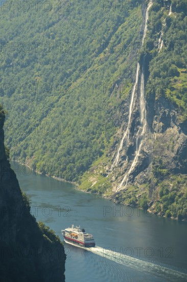 Ship MS Polarlys in fjord, waterfall, Bringefossen also called Gomsdalsfossen, Geirangerfjord, forest area, Geiranger, Møre og Romsdal, Norway, Scandinavia, Europe, adventure trip, viewing platform, viewpoint, mountainside, fjord, tourism, Gjerdefossen viewpoint, Hurtigruten, Hurtigruten voyage, cruise, cruise ship, Møre og Romsdal, NOR, travel, destination, ship, cruise, sightseeing, tourism, UNESCO World Heritage Site, Norwegian, Scandinavian, tourist, Ørnesvingen viewpoint