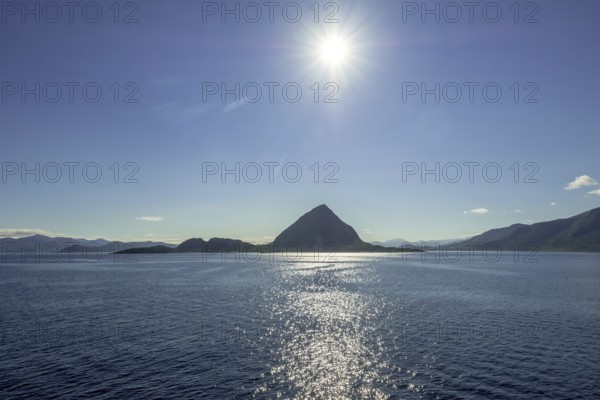Backlight, island near Godøya, Møre og Romsdal, Norway, Scandinavia, Europe, adventure travel, mountain formation, tourism, Godøya, Hurtigruten, Hurtigruten voyage, cruise, Møre og Romsdal, NOR, travel, destination, sea voyage, sightseeing, sun, star shape, tourism, blue sea, Norwegian, Scandinavian, tourist, northland voyage, northern sea, ship passage