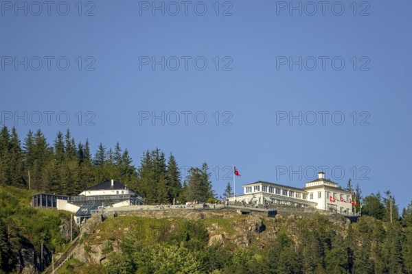 Fløyen, Fløien Folkerestaurant, lookout station over Bergen, mountain railway, white wooden building, country flags, trees, sky, Hordaland, Norway, Scandinavia, Europe, Bergen, NOR, travel, tourism, destination, sightseeing, sea voyage, Hurtigruten, Hurtigruten trip, tourism, Norwegian, Scandinavian, tourist, cruise, adventure trip, hotel in the mountains, rocks, stones, flags, stairs
