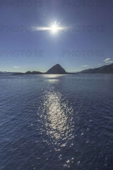 Backlight, island near Godøya, Møre og Romsdal, Norway, Scandinavia, Europe, adventure travel, mountain formation, tourism, Godøya, Hurtigruten, Hurtigruten voyage, cruise, Møre og Romsdal, NOR, travel, destination, sea voyage, sightseeing, sun, star shape, tourism, blue sea, Norwegian, Scandinavian, tourist, northland voyage, northern sea, ship passage