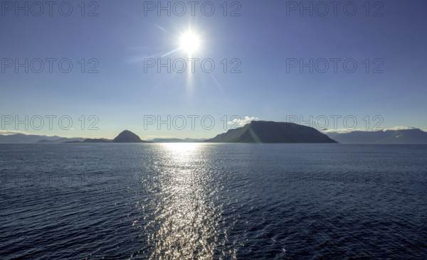 Backlight, island near Godøya, Møre og Romsdal, Norway, Scandinavia, Europe, adventure travel, mountain formation, tourism, Godøya, Hurtigruten, Hurtigruten voyage, cruise, Møre og Romsdal, NOR, travel, destination, sea voyage, sightseeing, sun, star shape, tourism, blue sea, Norwegian, Scandinavian, tourist, northland voyage, northern sea, ship passage