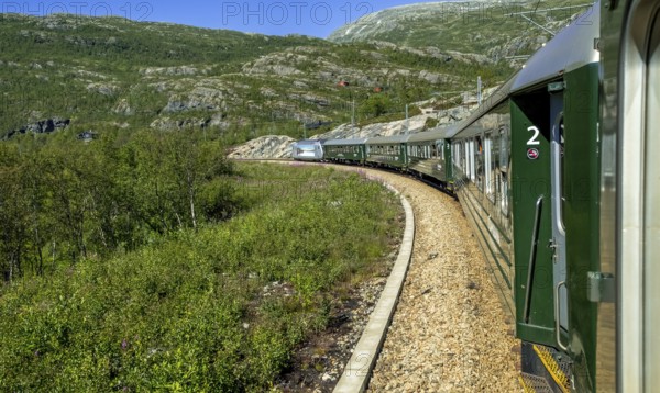 Flam Railway in the mountains, near Fureberget, trees, sky, Flåm, Sogn og Fjordane, Norway, Scandinavia, Europe, Flåm, NOR, travel, tourism, destination, sightseeing, sea voyage, Hurtigruten, Hurtigruten trip, tourism, Norwegian, Scandinavian, tourist, cruise, adventure trip, train, carriages, railway journey, tour, forest, travelling on the Flam Railway, Flam Railway