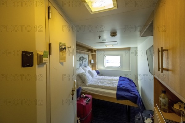 Cabin in cruise ship Polarlys, wolf picture, bed, window, Bergen, Hordaland, Norway, Scandinavia, Europe, NOR, travel, tourism, destination, sightseeing, sea voyage, Hurtigruten, Hurtigruten trip, tourism, Norwegian, Scandinavian, tourist, cruise, adventure trip, double bed, suitcase, wardrobe, smoke detector, door, mirror