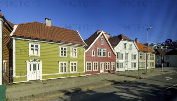 Colourful row of wooden houses in the city of Bergen, street with traffic lights, street lamp, sign, sky, Hordaland, Norway, Scandinavia, Europe, Bergen, NOR, travel, tourism, destination, sightseeing, sea voyage, Hurtigruten, Hurtigruten trip, tourism, Norwegian, Scandinavian, tourist, cruise, adventure trip, pavement, red traffic lights, city centre, buildings, roofs, windows, doors, travel by Flam Railway, Flam Railway