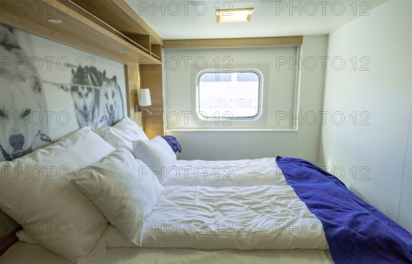 Cabin in cruise ship Polarlys, wolf picture, bed, window, Bergen, Hordaland, Norway, Scandinavia, Europe, NOR, travel, tourism, destination, sightseeing, sea voyage, Hurtigruten, Hurtigruten trip, tourism, Norwegian, Scandinavian, tourist, cruise, adventure trip, double bed, suitcase, wardrobe, smoke detector, door, mirror