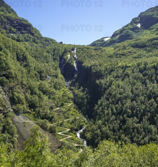 Kjosfossen waterfall, waterfall near Fureberget, mountain, forest, road, sky Flåm, Sogn og Fjordane, Norway, Scandinavia, Europe, Flåm, NOR, travel, tourism, destination, sightseeing, sea voyage, Hurtigruten, Hurtigruten trip, tourism, Norwegian, Scandinavian, touristic, cruise, adventure trip, waterfall, mountains, rock faces, trees, roads, train journey, tour, travel by Flam Railway, Flam Railway
