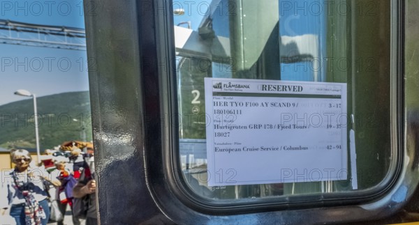Travel on the Flam Railway, iron railway journey, Flam Railway reservation information sheet, train window, Flåm, Sogn og Fjordane, Norway, Scandinavia, Europe, Flåm, NOR, travel, tourism, destination, sightseeing, sea voyage, Hurtigruten, Hurtigruten voyage, tourism, Norwegian, Scandinavian, tourist, cruise, adventure travel