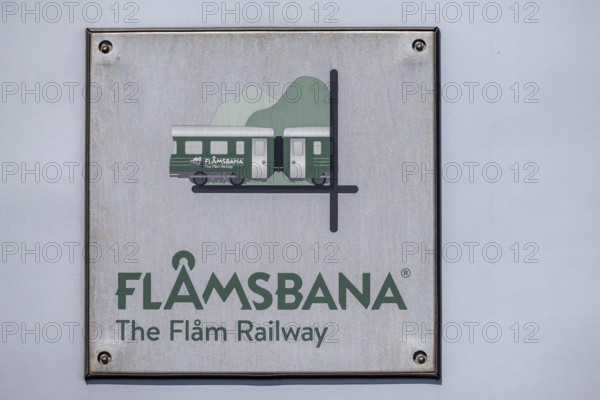 Journey on the Flam Railway, iron railway, white sign with green lettering Flåmsbana, The Flam Railway, Sogn og Fjordane, Norway, Scandinavia, Europe, Flåm, NOR, travel, tourism, destination, sightseeing, sea voyage, Hurtigruten, Hurtigruten trip, tourism, Norwegian, Scandinavian, tourist, cruise, adventure trip, tile