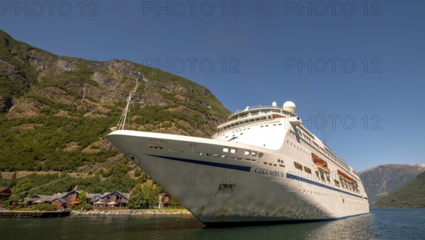 Excursion ship COLUMBUS, fjord, Nærøyfjorden, harbour, Stasjonsvegen, Varhaug, mountains, forests, wooden houses, blue sky, Flåm, Gudvangen, Sogn og Fjordane, Norway, Scandinavia, Europe, Flåm, NOR, travel, tourism, destination, sightseeing, sea voyage, Hurtigruten, Hurtigruten trip, tourism, Norwegian, Scandinavian, tourist, cruise, adventure trip, pier, hills, cliffs, station