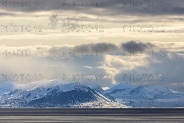 Snow-covered mountains by the sea, clouds, Longyearbyen, Spitsbergen, Svalbard