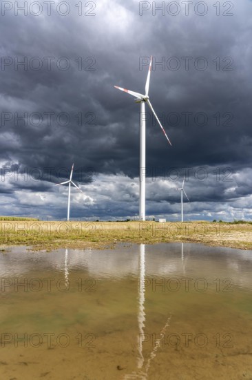 Wind farm, wind turbines, south of the village of Holzweiler, in the Rhenish lignite mining area south of the Garzweiler open-cast mine, dark storm clouds, North Rhine-Westphalia, Germany