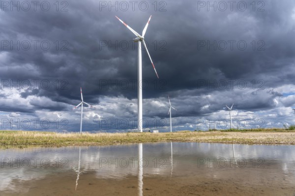 Wind farm, wind turbines, south of the village of Holzweiler, in the Rhenish lignite mining area south of the Garzweiler open-cast mine, dark storm clouds, North Rhine-Westphalia, Germany